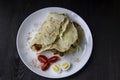 Sliced Ã¢â¬â¹Ã¢â¬â¹chicken with canned  cucumbers and cabbage in sauce, wrapped in pita bread on a white plate. Delicious for lunch or Royalty Free Stock Photo